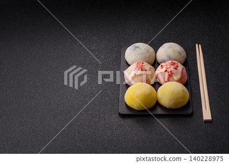 Japanese sweet frozen mochi with rice dough, fruit, and chocolate filling. Japanese mochi Japanese sweet frozen mochi with rice dough, fruit, and chocolate filling. Japanese mochi 140228975