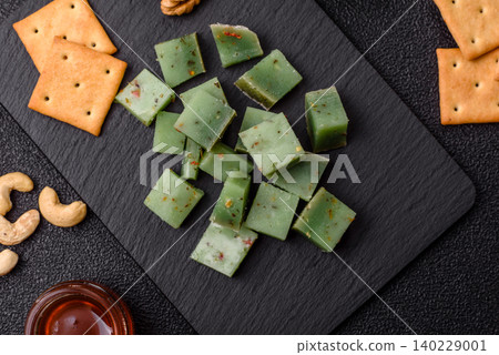 Hard green pesto cheese with herbs as a pasta ingredient. Green pesto cheese Hard green pesto cheese with herbs as a pasta ingredient. Green pesto cheese 140229001