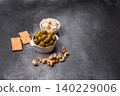 Whole green olives without pits in a bowl as an ingredient for cooking at home. Green olives 140229006