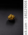 Whole green olives without pits in a bowl as an ingredient for cooking at home. Green olives 140229008