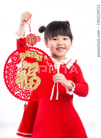 Little Asian girl holding a "Fu" (Good Fortune) character decoration, symbolizing good fortune for Lunar New Year. Little Asian girl holding a "Fu" (Good Fortune) character decoration, symbolizing good fortune for Lunar New Year. 140229552
