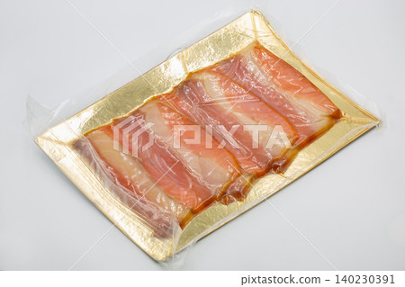 Vacuum packed slices of smoked fish closeup on white. Vacuum packed slices of smoked fish closeup on white. 140230391