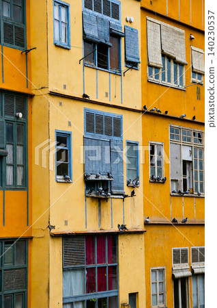 Colorful vintage house with pigeons sitting on windows in old town of Girona, Spain Colorful vintage house with pigeons sitting on windows in old town of Girona, Spain 140230537