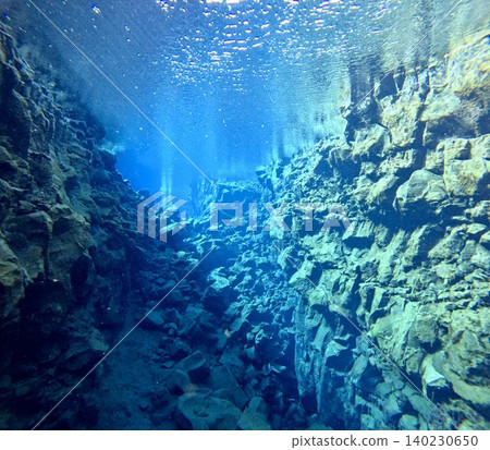A scene of people enjoying scuba diving at Silfra Rift in Þingvellir National Park, Iceland. A scene of people enjoying scuba diving at Silfra Rift in Þingvellir National Park, Iceland. 140230650