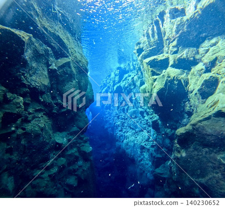 A scene of people enjoying scuba diving at Silfra Rift in Þingvellir National Park, Iceland. A scene of people enjoying scuba diving at Silfra Rift in Þingvellir National Park, Iceland. 140230652