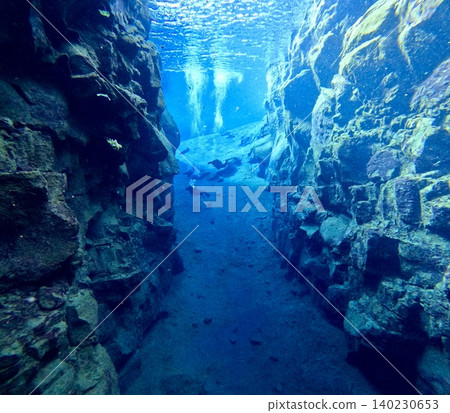 A scene of people enjoying scuba diving at Silfra Rift in Þingvellir National Park, Iceland. 140230653