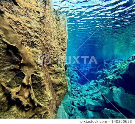 A scene of people enjoying scuba diving at Silfra Rift in Þingvellir National Park, Iceland. A scene of people enjoying scuba diving at Silfra Rift in Þingvellir National Park, Iceland. 140230658