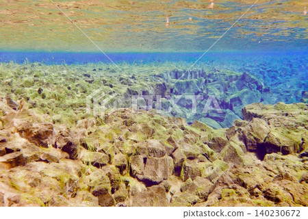 A scene of people enjoying scuba diving at Silfra Rift in Þingvellir National Park, Iceland. A scene of people enjoying scuba diving at Silfra Rift in Þingvellir National Park, Iceland. 140230672