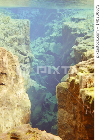 A scene of people enjoying scuba diving at Silfra Rift in Þingvellir National Park, Iceland. A scene of people enjoying scuba diving at Silfra Rift in Þingvellir National Park, Iceland. 140230675
