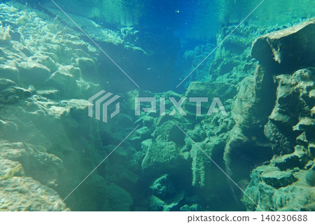 A scene of people enjoying scuba diving at Silfra Rift in Þingvellir National Park, Iceland. A scene of people enjoying scuba diving at Silfra Rift in Þingvellir National Park, Iceland. 140230688