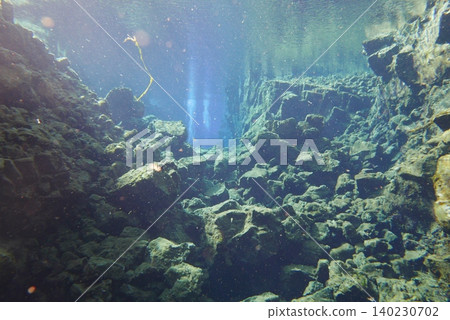 A scene of people enjoying scuba diving at Silfra Rift in Þingvellir National Park, Iceland. A scene of people enjoying scuba diving at Silfra Rift in Þingvellir National Park, Iceland. 140230702