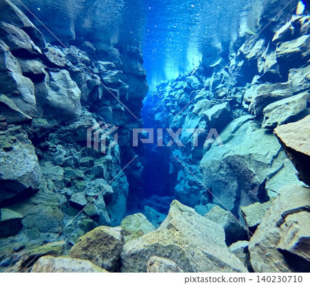 A scene of people enjoying scuba diving at Silfra Rift in Þingvellir National Park, Iceland. A scene of people enjoying scuba diving at Silfra Rift in Þingvellir National Park, Iceland. 140230710