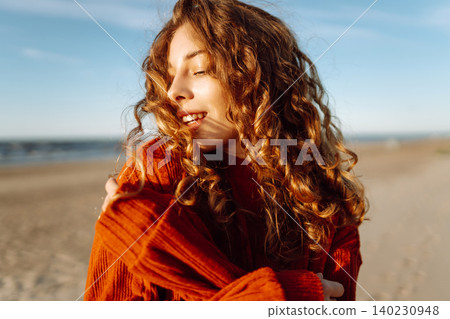 Positive young female in warm clothes smiling and looking at camera. Spring time. Travel, weekend. Positive young female in warm clothes smiling and looking at camera. Spring time. Travel, weekend. 140230948