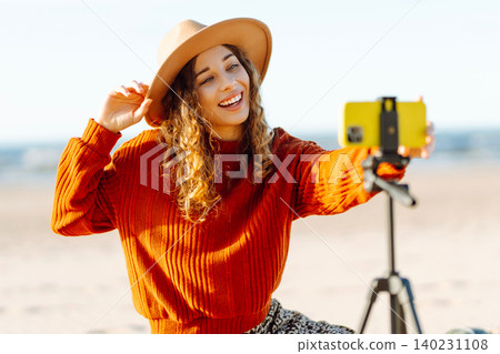 Style woman using smartphone with stabilizer. Travel, blogging, technology concept. Style woman using smartphone with stabilizer. Travel, blogging, technology concept. 140231108