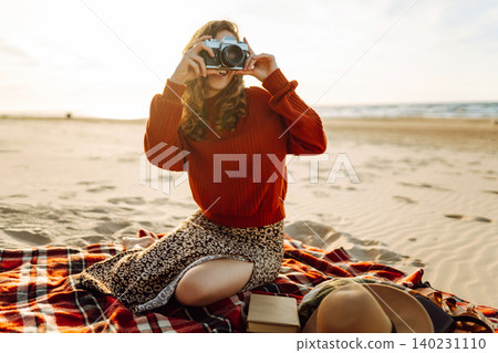 Young woman walking at the beach and taking photos captures the beauty of nature. Travel blog Young woman walking at the beach and taking photos captures the beauty of nature. Travel blog 140231110