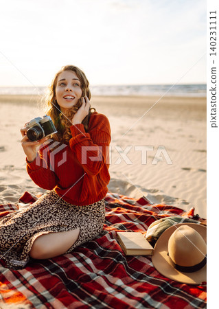 Young woman walking at the beach and taking photos captures the beauty of nature. Travel blog 140231111