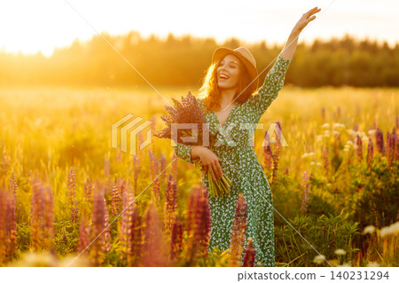 Young woman enjoying nature at sunset while walking. Nature concept. Young woman enjoying nature at sunset while walking. Nature concept. 140231294