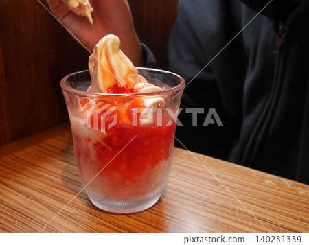 Strawberry shaved ice topped with soft serve ice cream 140231339