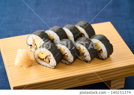 Thick sushi rolls served on wooden clogs Thick sushi rolls served on wooden clogs 140231374