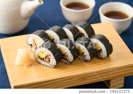 Thick sushi rolls served on wooden clogs Thick sushi rolls served on wooden clogs 140231375