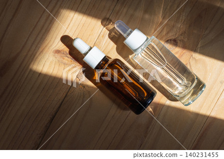 Two Cosmetic Dropper Bottles on Wood Two Cosmetic Dropper Bottles on Wood 140231455