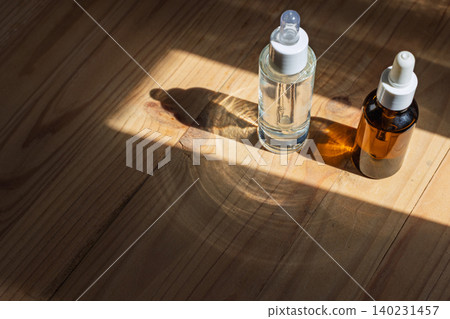 Two Glass Dropper Bottles casting Long Shadows Two Glass Dropper Bottles casting Long Shadows 140231457