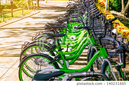 Bicycle sharing systems. Bicycle for rent business. Bicycle for city tour at bike parking station. Eco-friendly transport. Urban economy public transport. Bike station in the park. Healthy lifestyle. Bicycle sharing systems. Bicycle for rent business. Bicycle for city tour at bike parking station. Eco-friendly transport. Urban economy public transport. Bike station in the park. Healthy lifestyle. 140231885