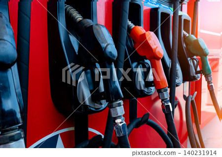 Gas pump nozzle in petrol station. Fuel nozzle in oil dispenser. Fuel dispenser machine. Refueling fill up with petrol gasoline and diesel. Petrol industry and service. Petroleum oil consumption. Gas pump nozzle in petrol station. Fuel nozzle in oil dispenser. Fuel dispenser machine. Refueling fill up with petrol gasoline and diesel. Petrol industry and service. Petroleum oil consumption. 140231914