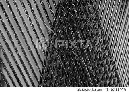 Architectural metal panel for decorative building wall. Black and silver metal decoration material. Twisted iron wire panel abstract background. Rough iron texture. Building wall architecture design. 140231959