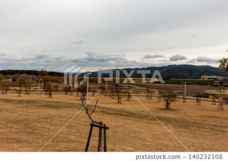 A vast park lawn and a winter mountain range landscape (copy space available) A vast park lawn and a winter mountain range landscape (copy space available) 140232108