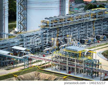 Industrial oil refinery and petrochemical plant with extensive steel pipelines and gas storage tanks. Infrastructure for the energy and fuel. Oil and gas refinery plant. Network of pipes and tanks. Industrial oil refinery and petrochemical plant with extensive steel pipelines and gas storage tanks. Infrastructure for the energy and fuel. Oil and gas refinery plant. Network of pipes and tanks. 140232217