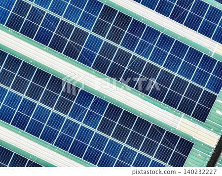 Aerial view of a warehouse rooftop featuring solar panels generating green electricity. The shift to renewable energy, clean power solutions, and environmental sustainability for modern industries. 140232227