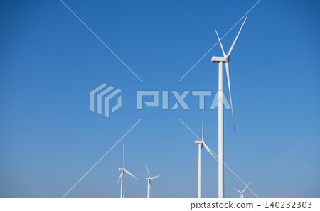 A group of wind turbines against blue sky, Wind energy. Wind power. Sustainable, renewable energy. Wind turbine generate electricity. Sustainable resources. Green technology for energy sustainability. 140232303