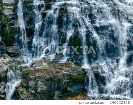 Aerial view of a waterfall in a lush tropical green forest in Doi Inthanon National Park, Chiang Mai, Thailand. This nature landscape showcases water sustainability and scenic travel destinations. 140232358