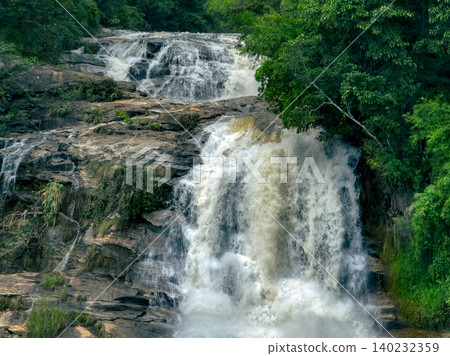 Waterfall in a lush tropical green forest in Doi Inthanon National Park, Chiang Mai, Thailand. This nature landscape showcases water sustainability and scenic travel destinations. Water conservation. 140232359