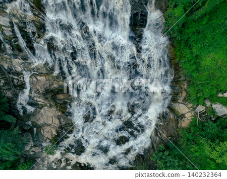 Aerial view of a waterfall in a lush tropical green forest in Doi Inthanon National Park, Chiang Mai, Thailand. This nature landscape showcases water sustainability and scenic travel destinations. 140232364