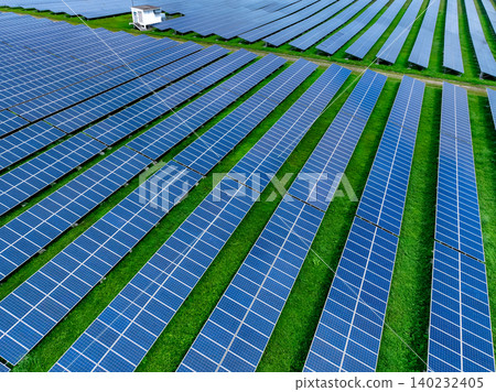 Aerial view of solar farm. Sustainable renewable energy and modern photovoltaic technology for eco-friendly electricity production. Solar power station. Green energy solutions. Solar panel technology. Aerial view of solar farm. Sustainable renewable energy and modern photovoltaic technology for eco-friendly electricity production. Solar power station. Green energy solutions. Solar panel technology. 140232405