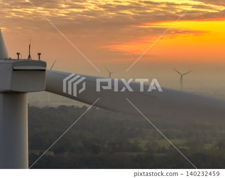 Wind farm field and sunset sky. Wind power. Sustainable, renewable energy. Wind turbines generate electricity. Sustainable development. Green technology for energy sustainability. Eco-friendly energy. 140232459