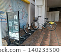 A shared bicycle station set up in front of the shutter of a closed store, featuring a cute illustration of the store. A shared bicycle station set up in front of the shutter of a closed store, featuring a cute illustration of the store. 140233500