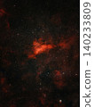 A bright red nebula is visible against a dark sky filled with numerous white stars. 140233809