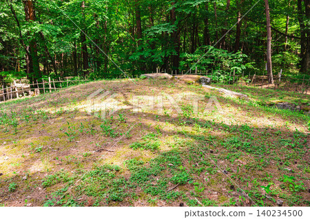 The remains of the Hiraide burial mounds and the lush green grove of trees. The remains of the Hiraide burial mounds and the lush green grove of trees. 140234500