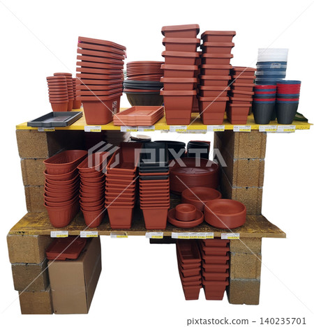 Various flower pots and gardening containers stacked on shelves for sale 140235701