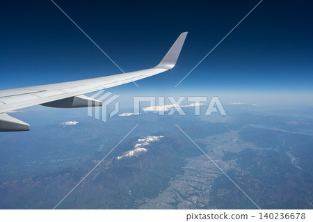 Views of the Central Alps, Mount Ontake, Mount Norikura, and the Northern Alps from an airplane window. Views of the Central Alps, Mount Ontake, Mount Norikura, and the Northern Alps from an airplane window. 140236678