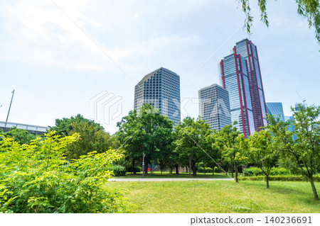 Seoul, South Korea - May. 24, 2026 : Scenic view of Yeouido financial district skyscrapers framed by lush green trees at Yeouido Park in Seoul, South Korea 140236691