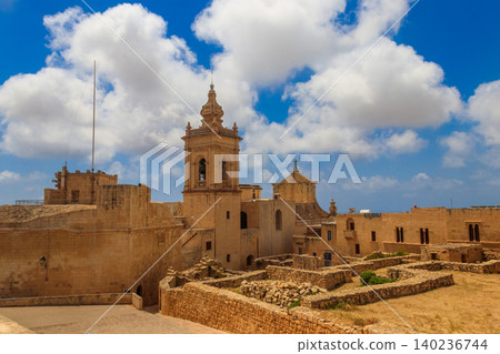 View of Cathedral of the Assumption, historic stone walls and  ancient architecture in the Cittadella, also known as the Castello, citadel of Victoria on the island of Gozo, Malta 140236744