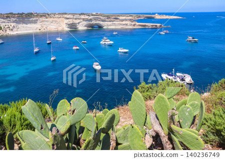 Beautiful coastal view of Delimara peninsula with rocks and turquoise sea with yachts on Malta 140236749