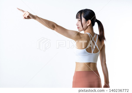 A fit and stylish woman who works out: confidence, goals, pointing, starting, leggings, trimming up. A fit and stylish woman who works out: confidence, goals, pointing, starting, leggings, trimming up. 140236772