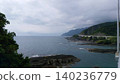 A bridge spanning a mountain along the coast 140236779