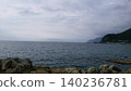 A tranquil lake shrouded in morning mist and a fantastical mountain landscape. 140236781