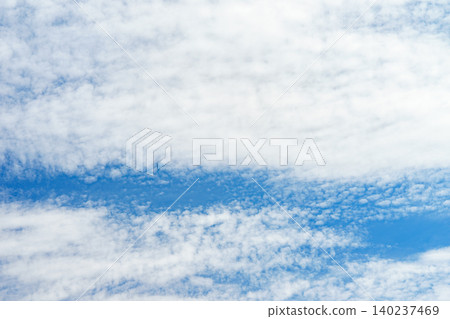 Blue sky with white clouds in sunny day. Beauty clear cloudy sky in sunshine calm air bacground Blue sky with white clouds in sunny day. Beauty clear cloudy sky in sunshine calm air bacground 140237469